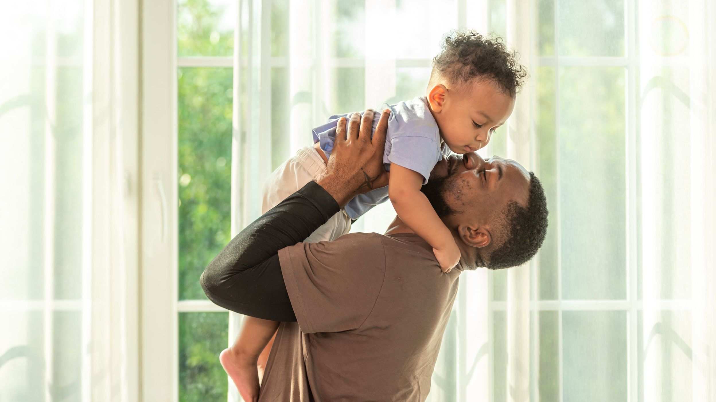Dad holding up his son